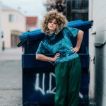 woman posing in front of trash